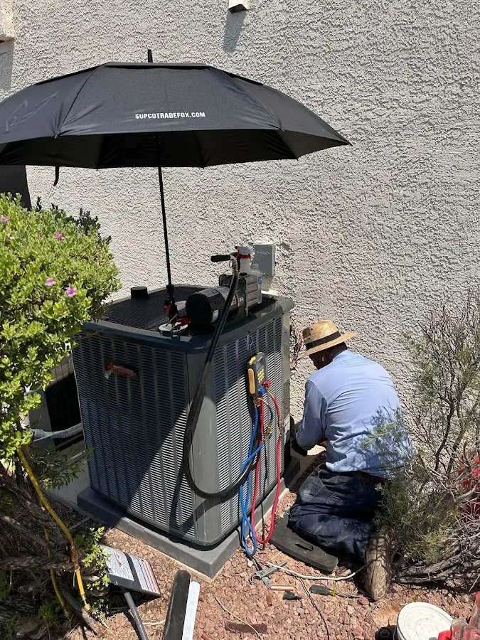 HVAC technician performing outdoor AC maintenance in Pleasant Prairie